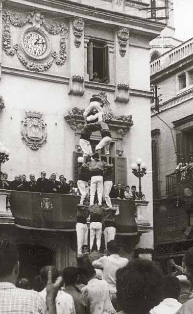Pilar de cinc el 31-VIII-1962, amb el Mènec, l’Estevet Puig, el Ramonet i el fill de l’Àngel Batet; a banda i banda del pilar, a la façana de cal Parera (al pis de dalt hi havia l’emissora de Ràdio Vilafranca) es distingeixen bé els dibuixos corresponents al termòmetre casteller que informava de l’estat econòmic de la campanya pro-monument «Als Castellers» (col·lecció Josep Miret).
